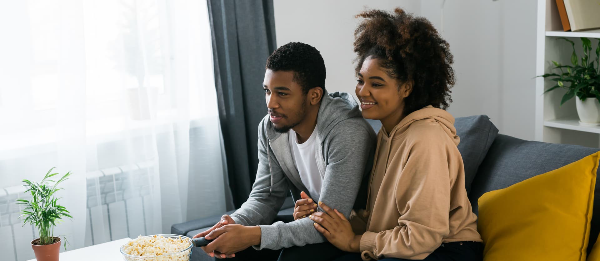 Couple planning their move in a bright living room